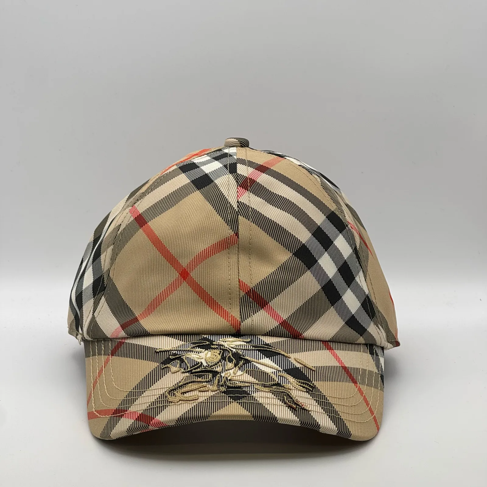 Beige check Burberry cap, front view showing the equestrian knight design on the brim.