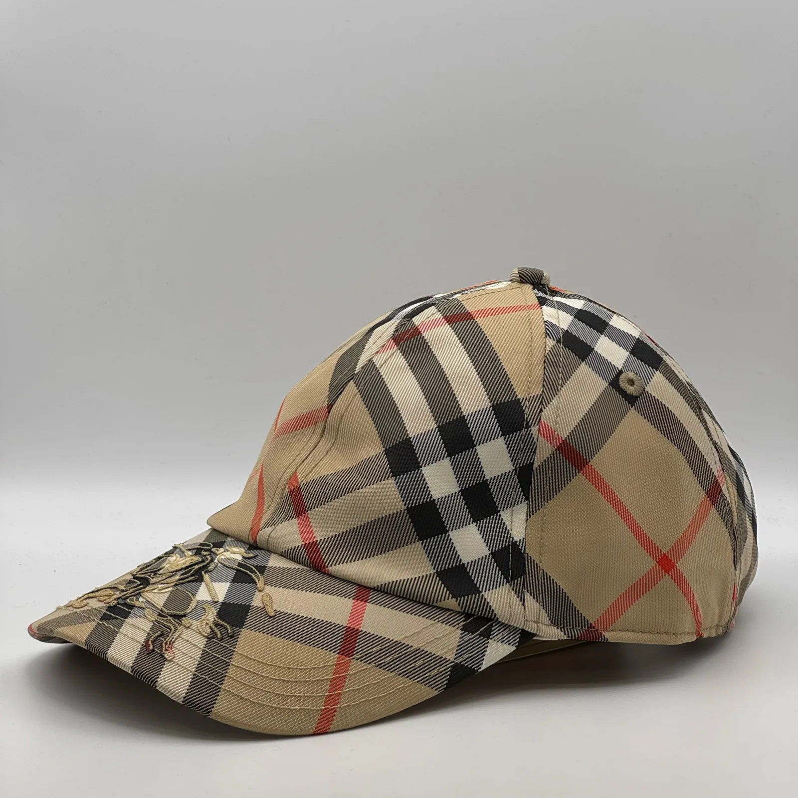 Beige check Burberry cap, side profile.
