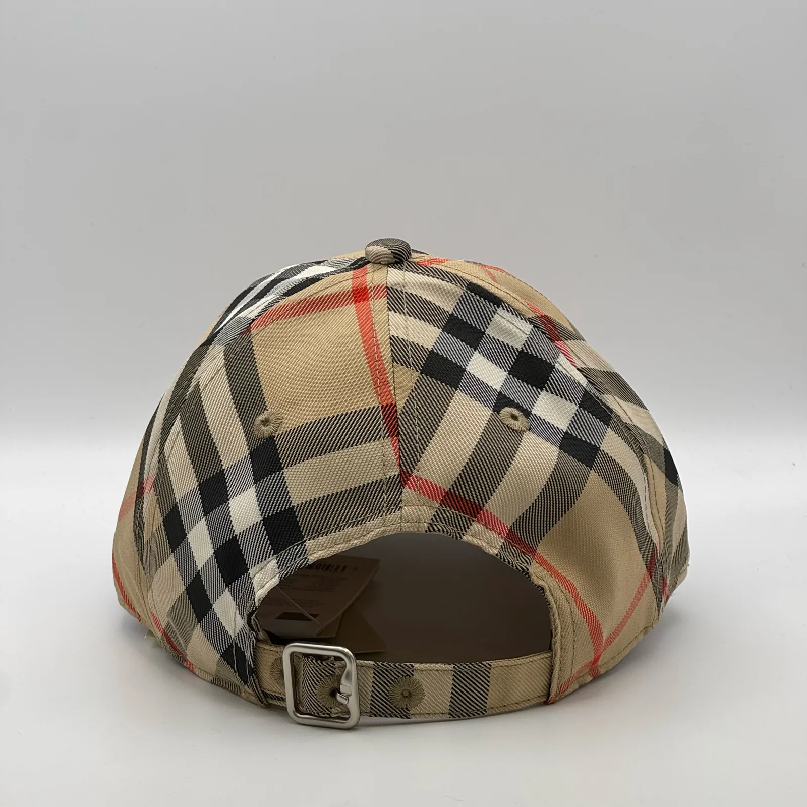 Beige check Burberry cap, back view showing the metal buckle strap.