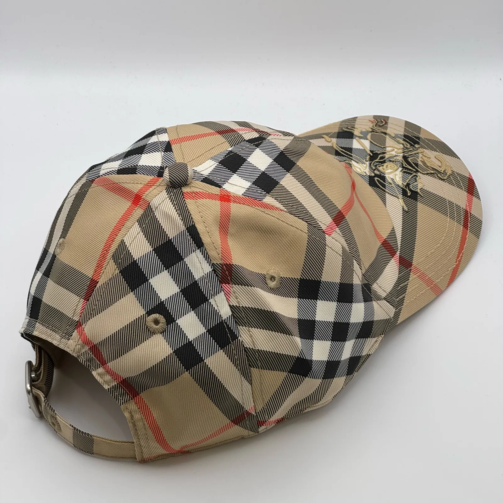 Beige check Burberry cap, elevated three-quarter view of the crown.