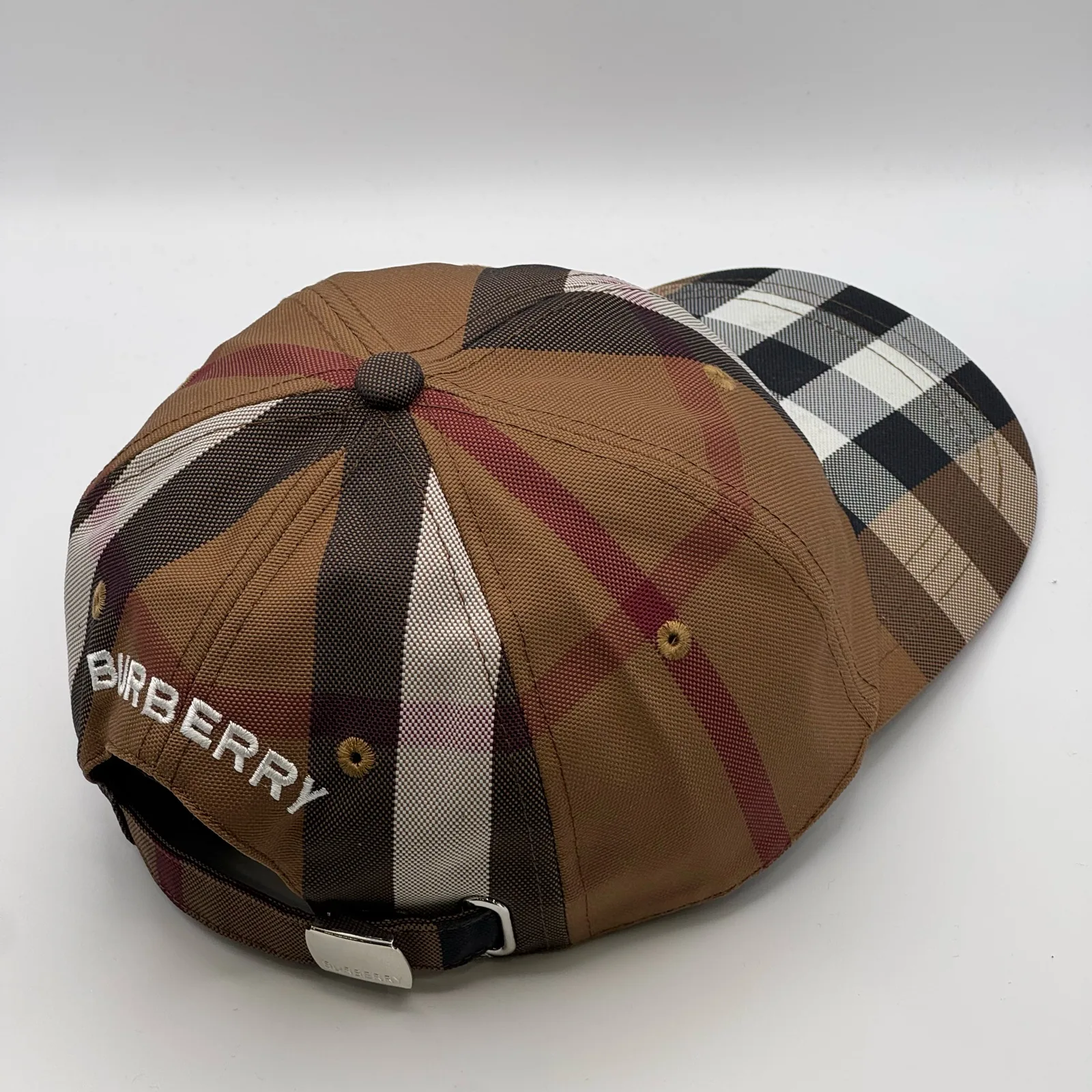 Brown check Burberry cap, elevated three-quarter view of the crown.