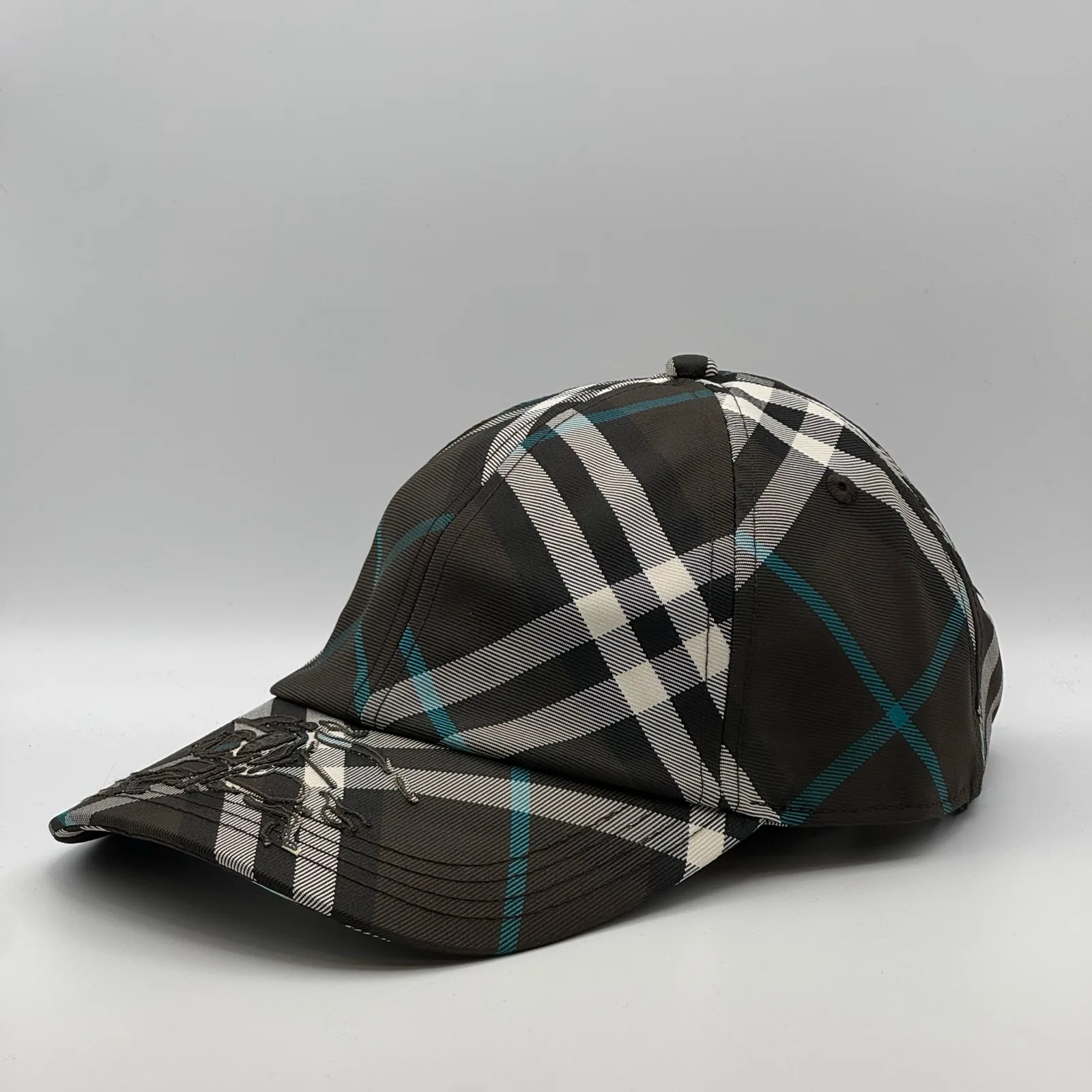 Dark brown check Burberry cap, side profile.