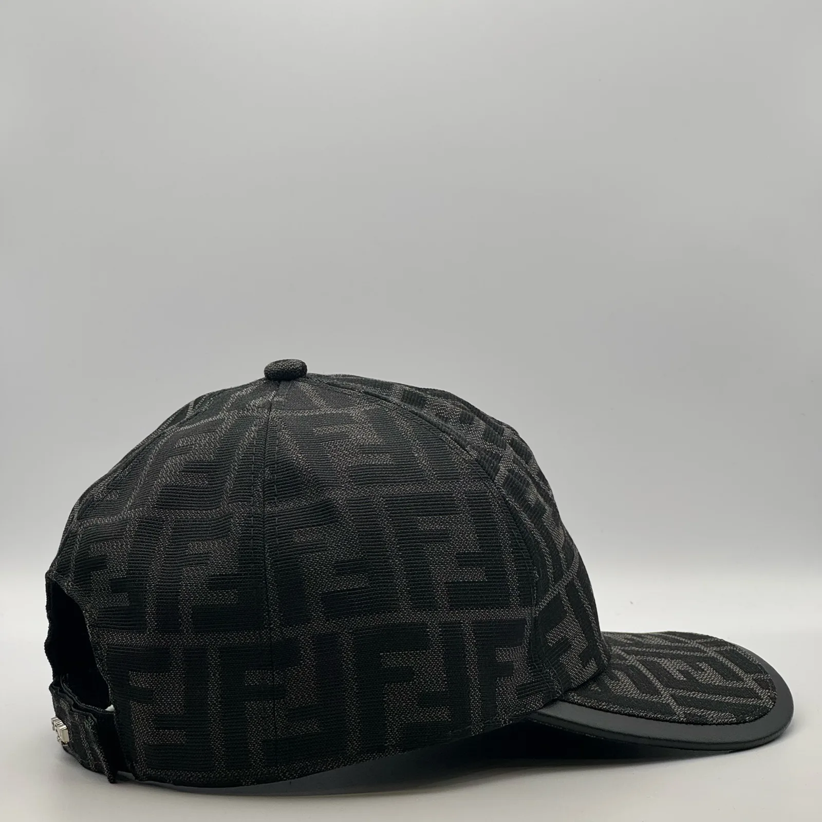 Close-up of the buckle closure at the back of the black-on-black FF cap.