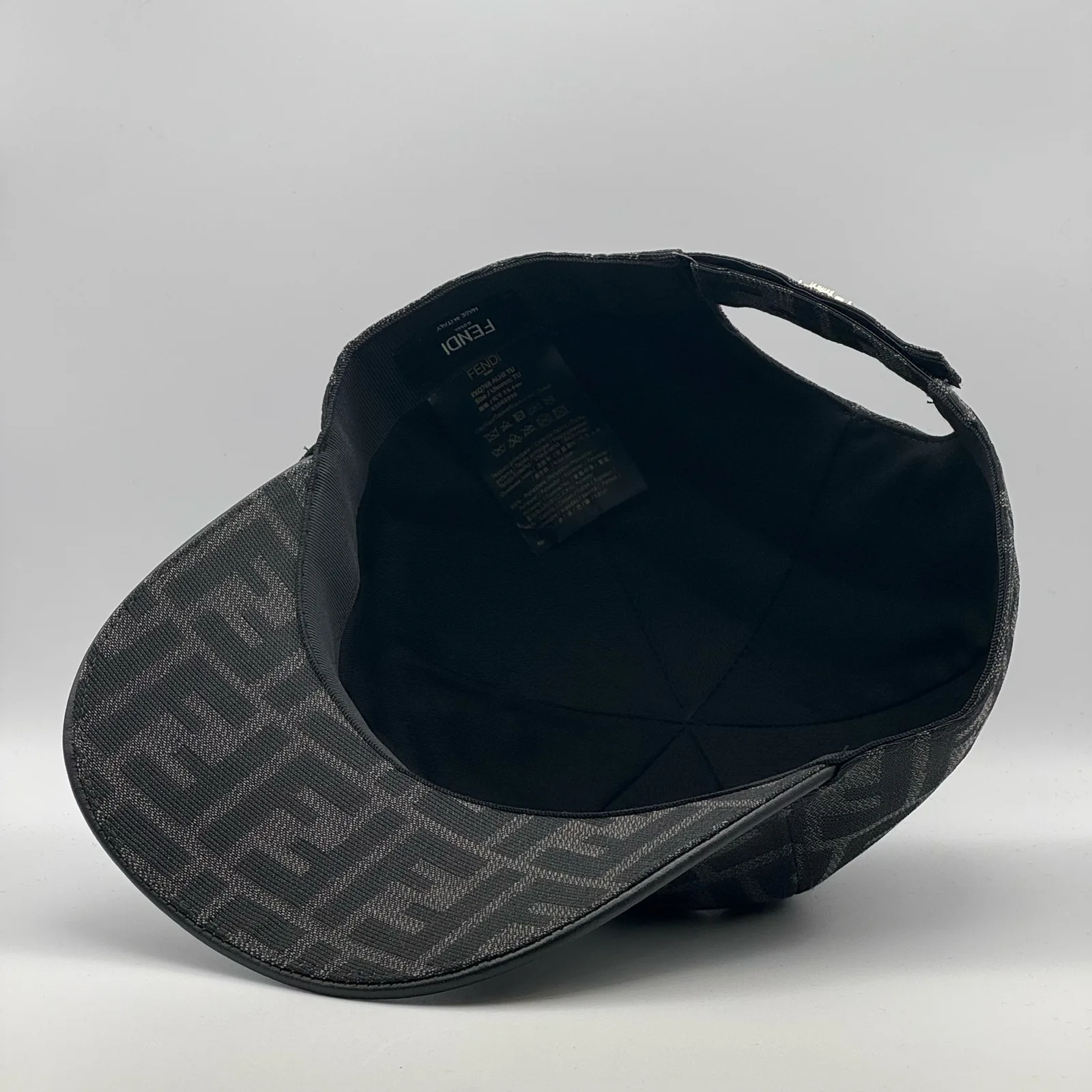 Underside of the black-on-black FF cap, brim lifted to show the interior.