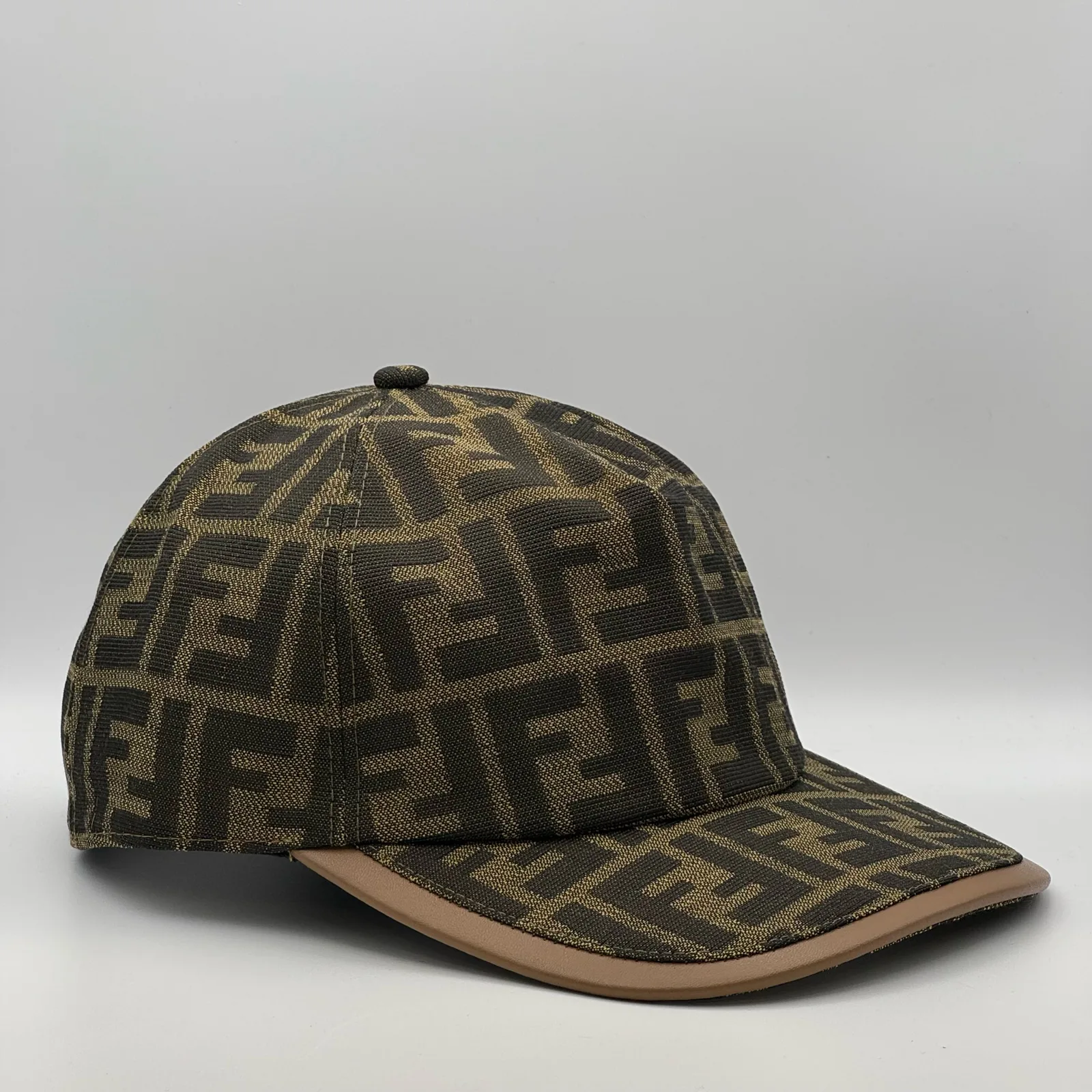 Brown Fendi FF cap, side profile showing the tan leather-look brim binding.