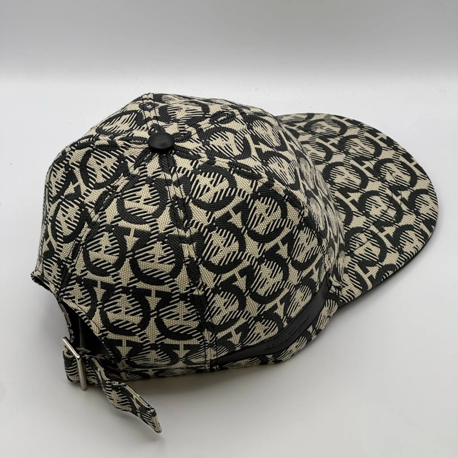 Ferragamo Gancini cap, rear side view showing the strap tab hanging free.