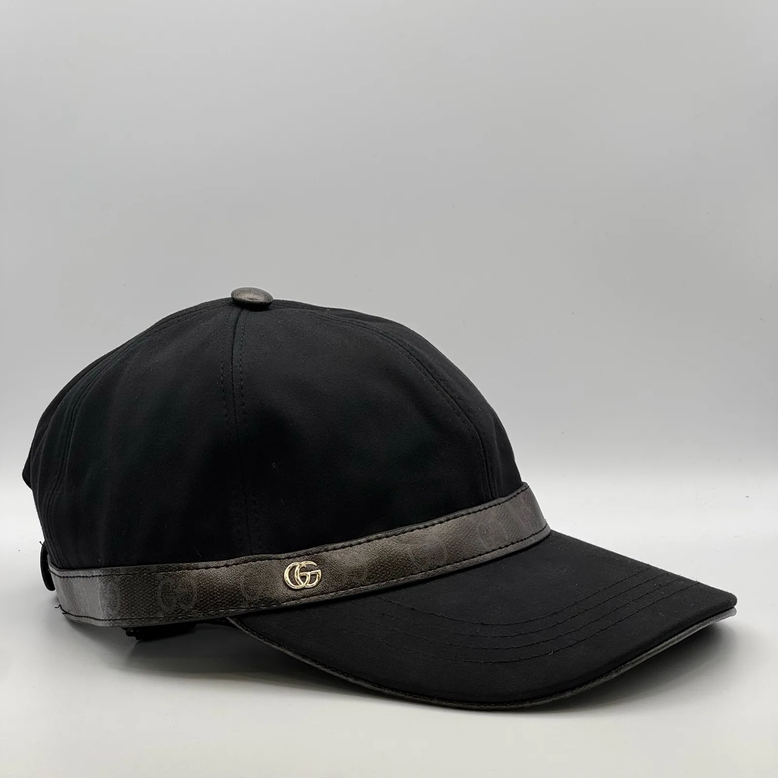 Black GG band cap, three-quarter view showing brim trim