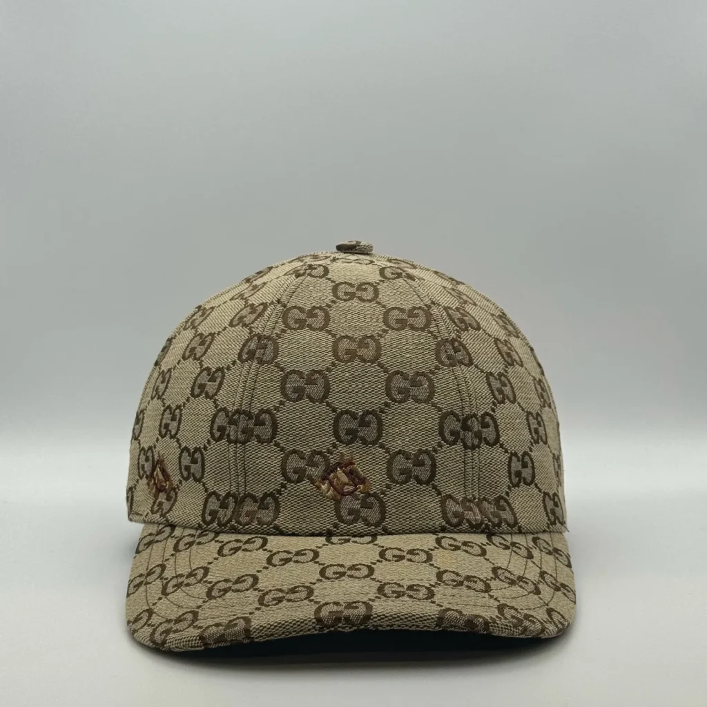 Beige GG canvas cap, front three-quarter view with a bee embroidery patch