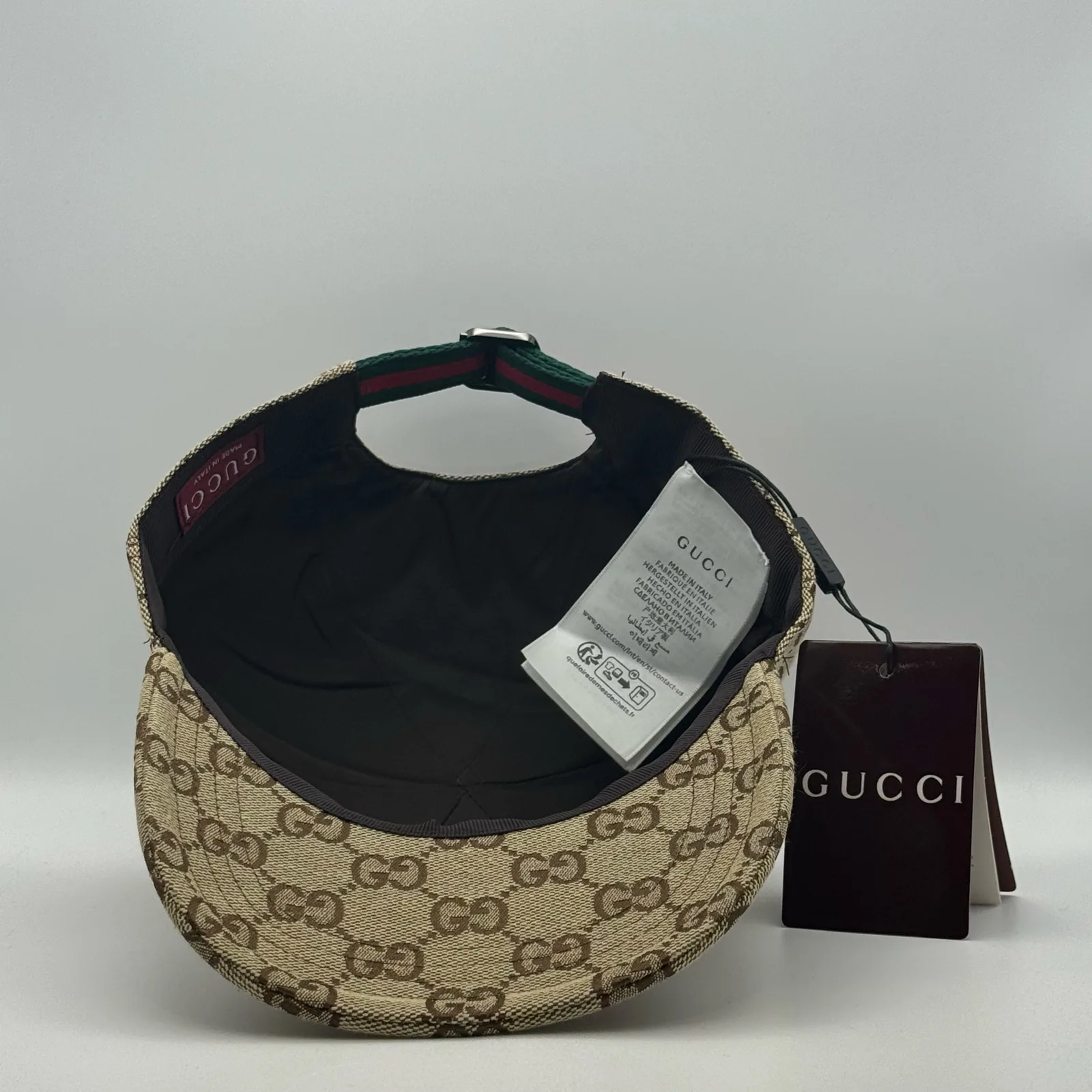 Beige GG canvas cap, interior view with brand booklet and tag