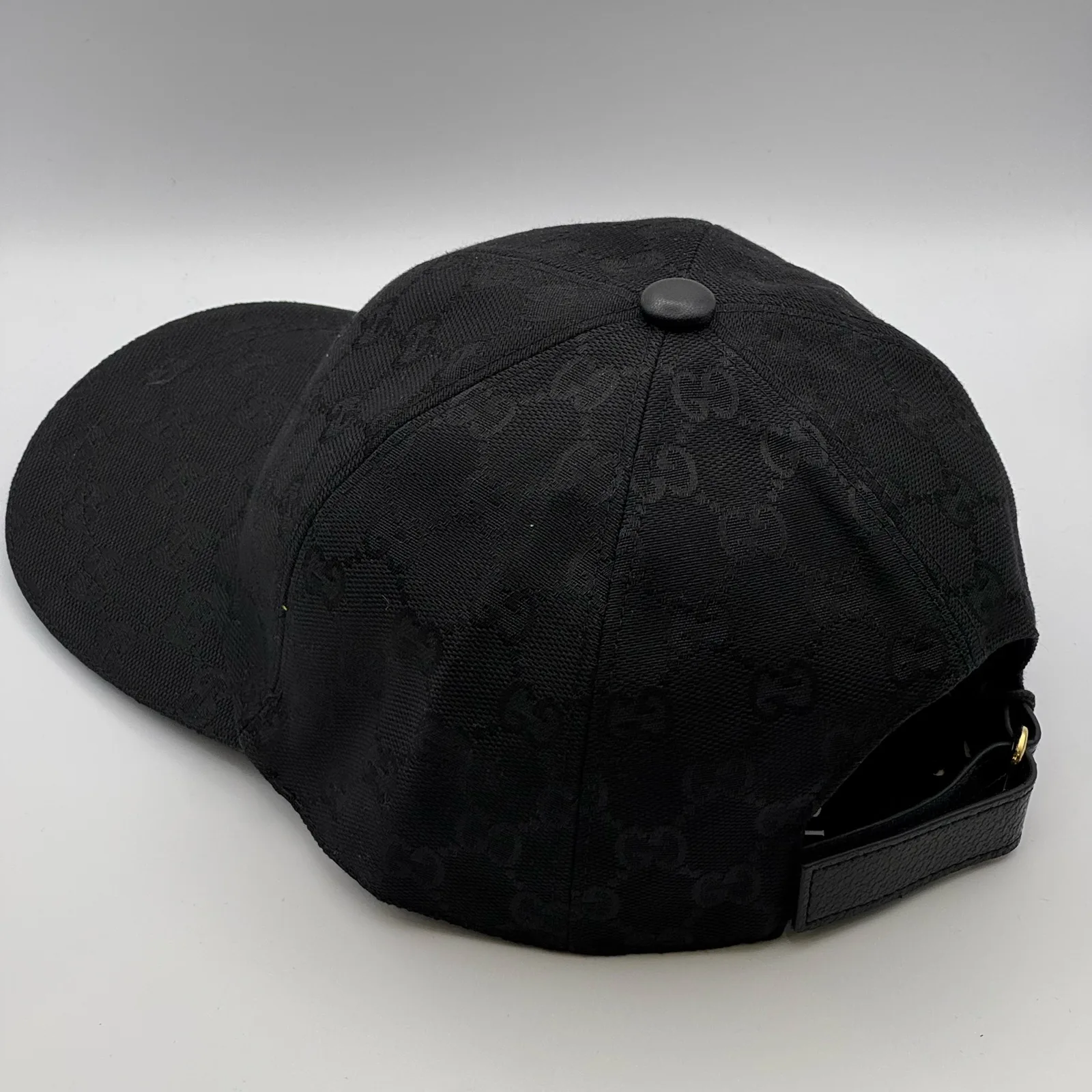 Black GG canvas cap, three-quarter back view showing the crown and brim