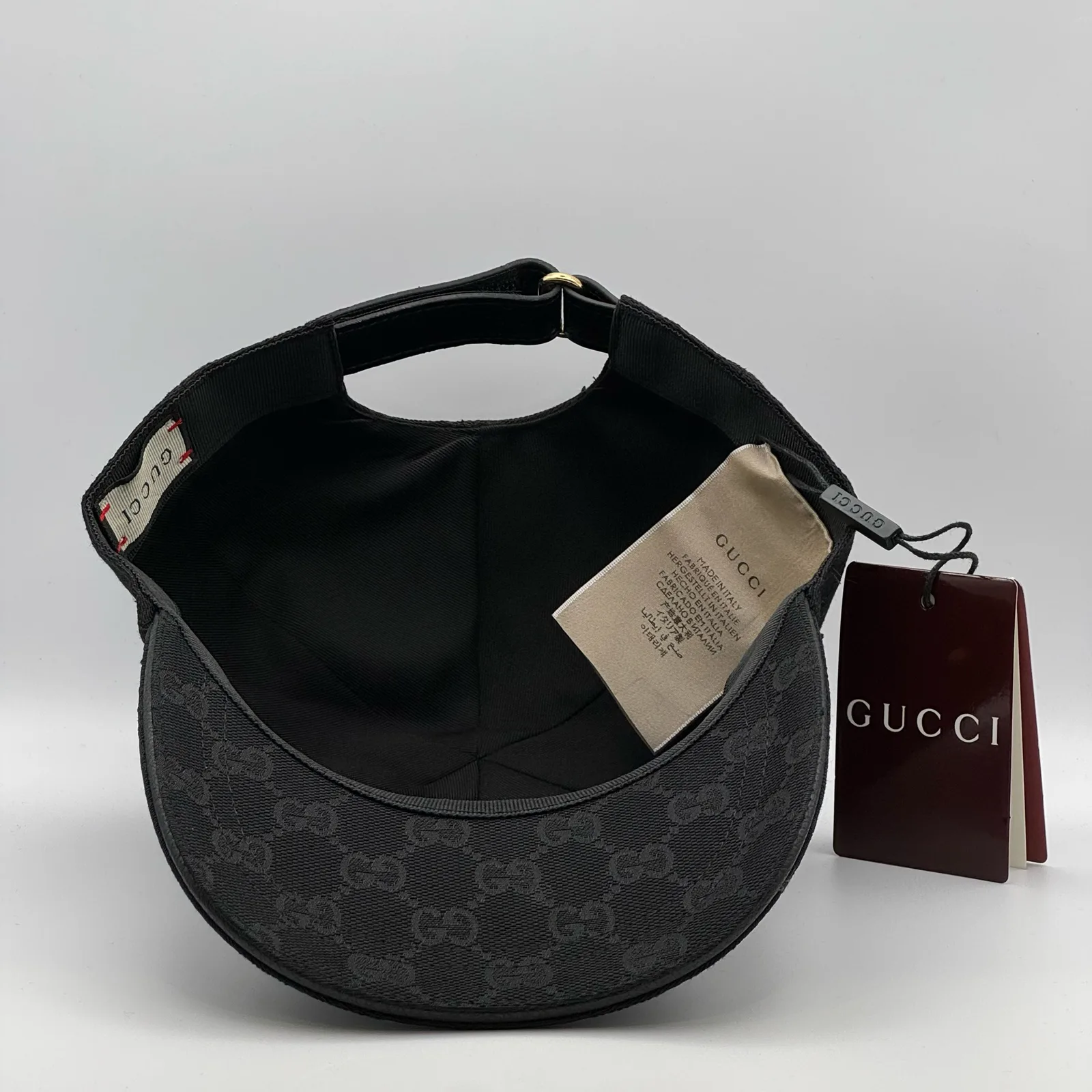 Black GG canvas cap, interior view with brand booklet and tag