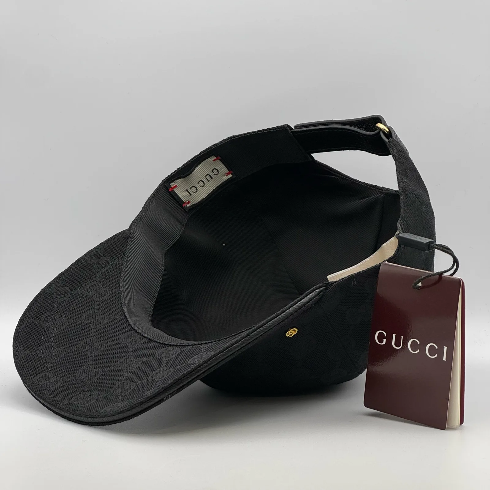 Black GG canvas cap, interior view showing the black lining and hanging tag