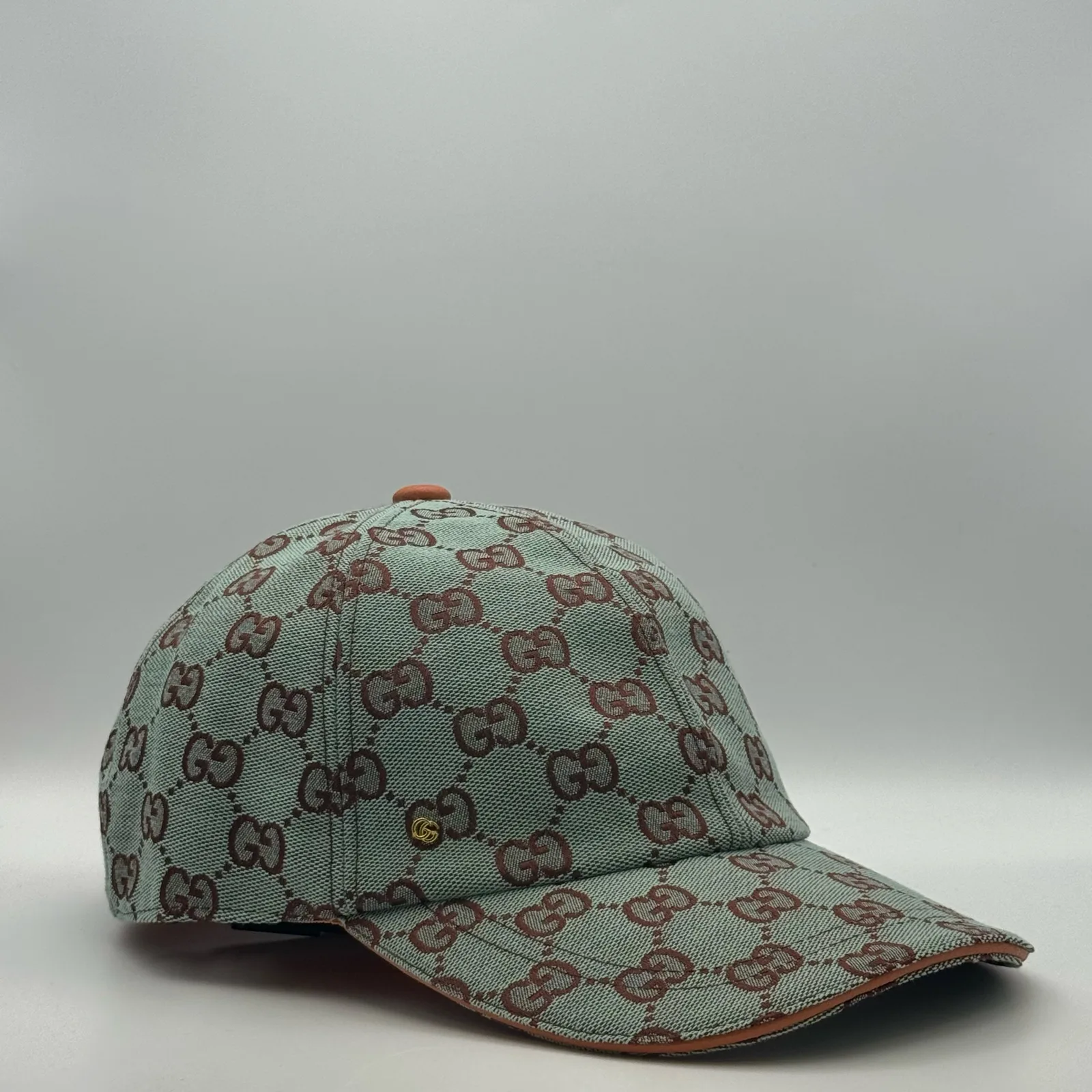 Mint green GG canvas cap, side view showing the tan leather brim and strap