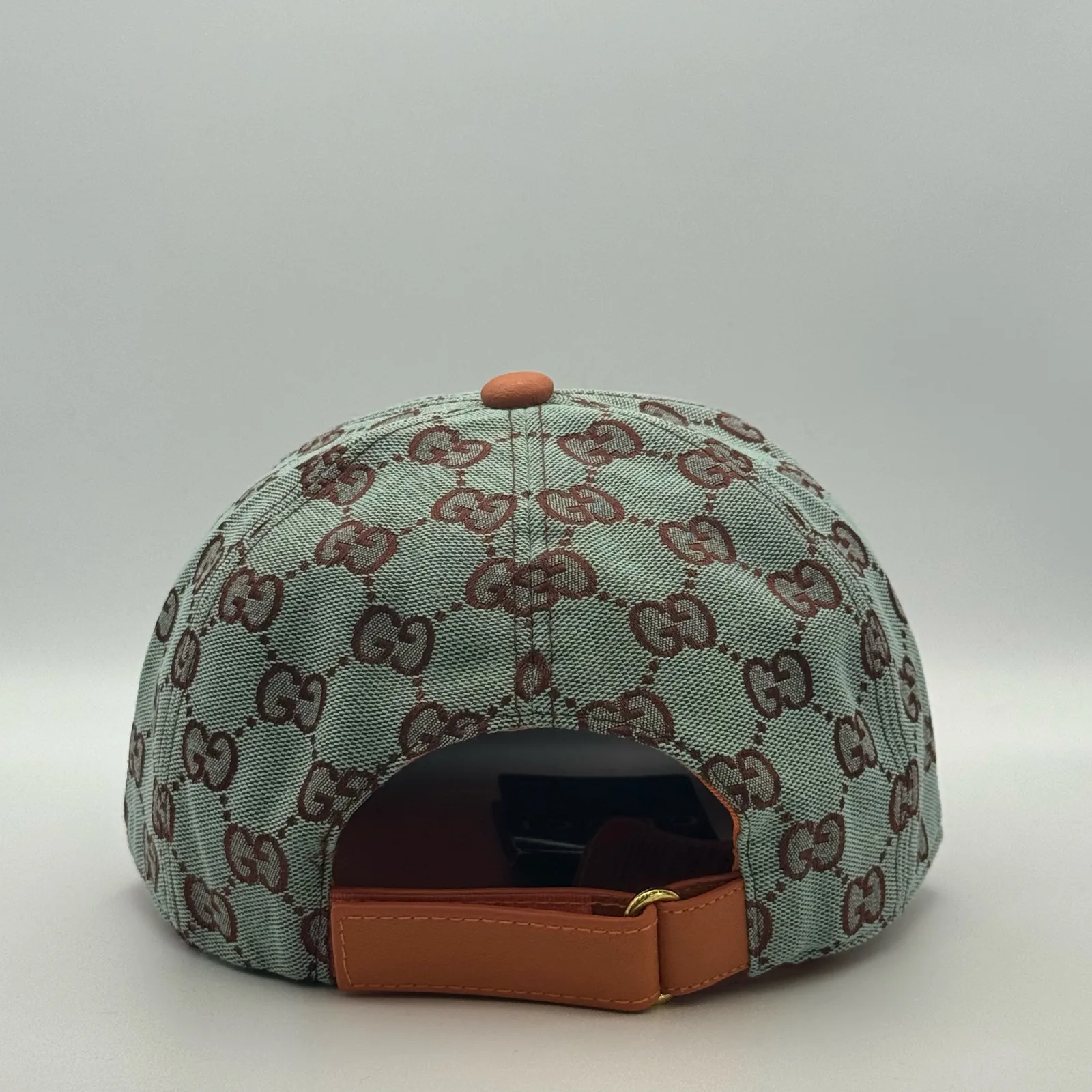 Mint green GG canvas cap, back view with tan leather strap and buckle