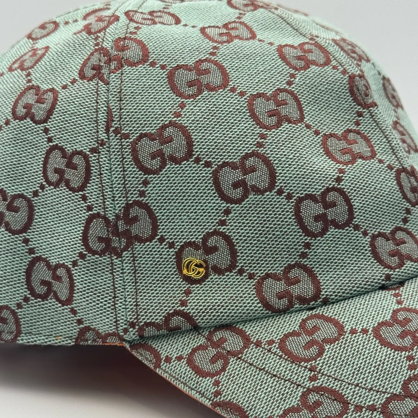 Mint green GG canvas cap, close-up of the canvas weave and small gold logo hardware
