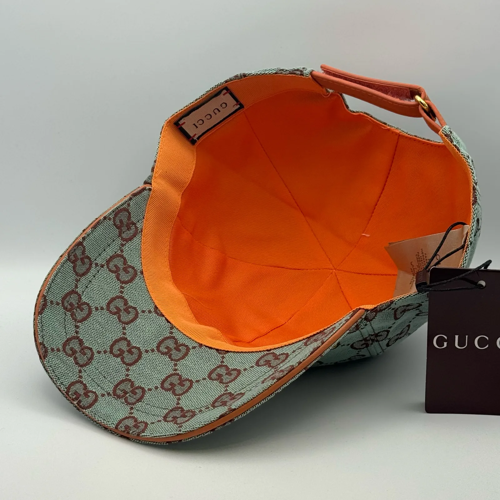 Mint green GG canvas cap, interior view showing the bright orange lining and tag