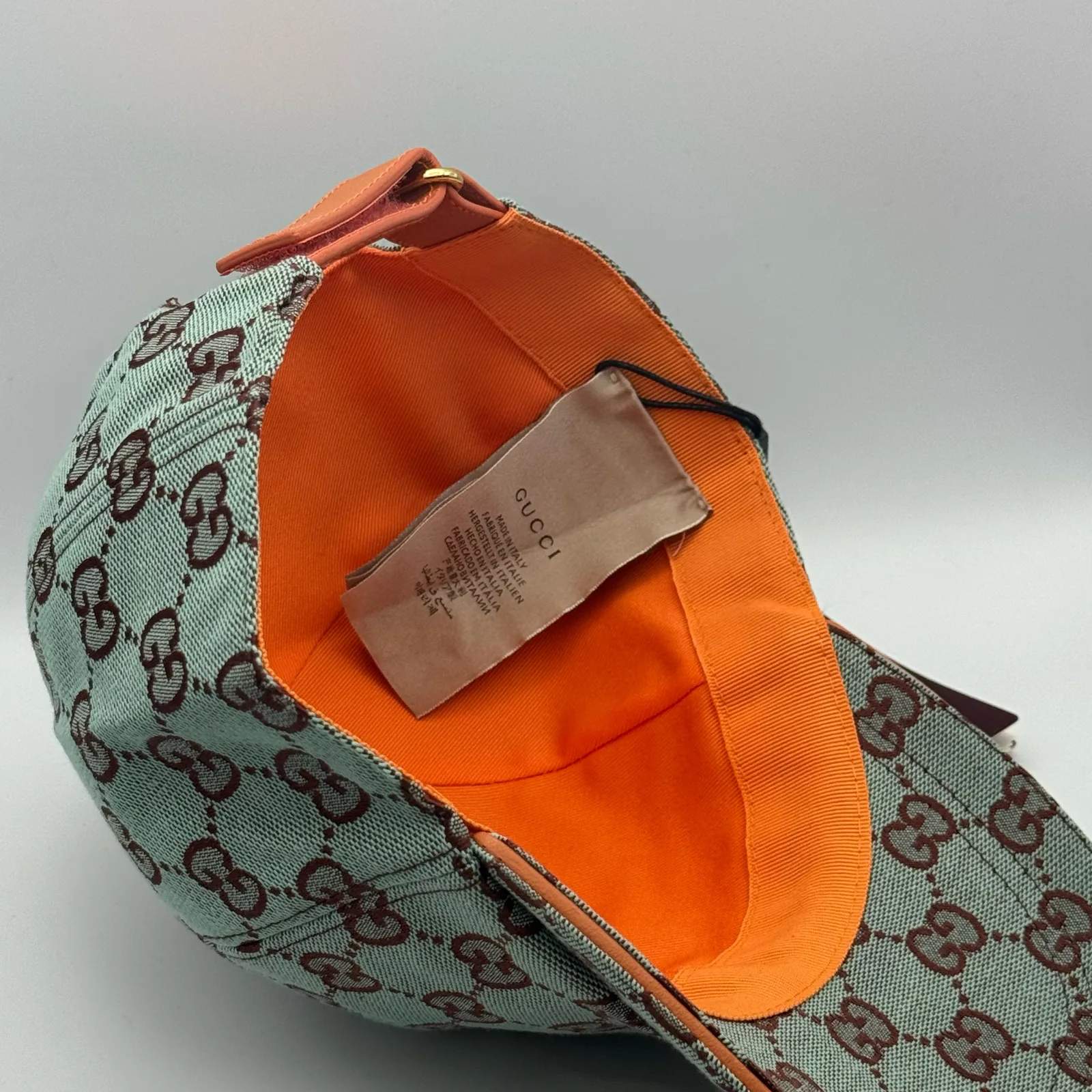 Mint green GG canvas cap, interior view showing the orange lining and hanging tag