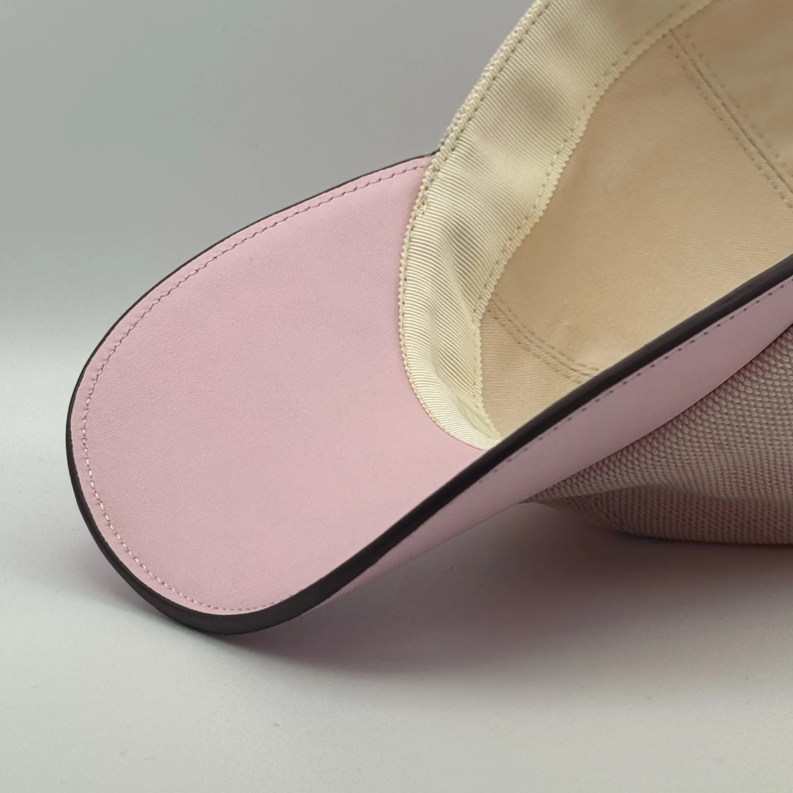 Close-up of the pink leather brim edge and stitching from underneath.