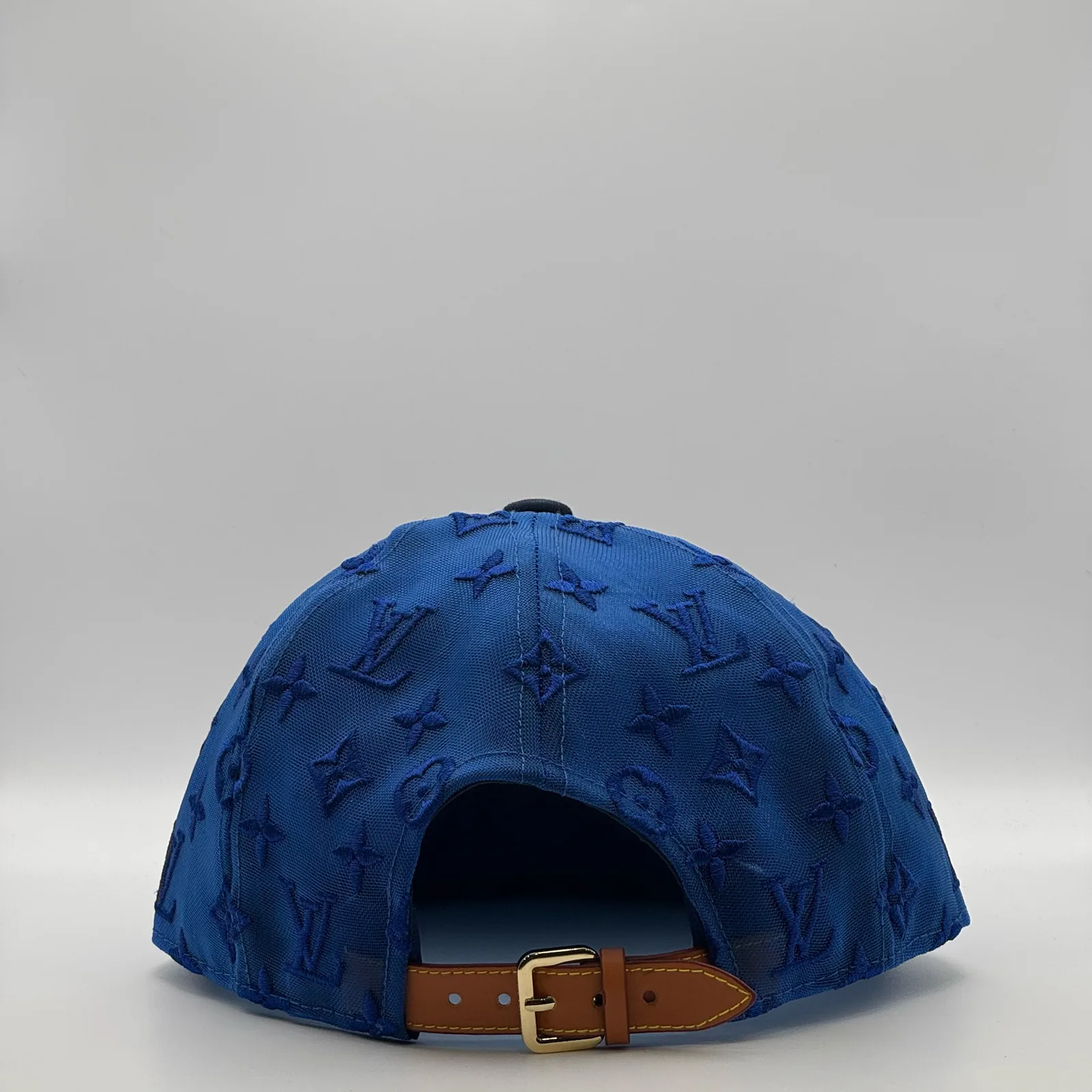 Navy logo mesh cap, back view showing the tan leather strap.