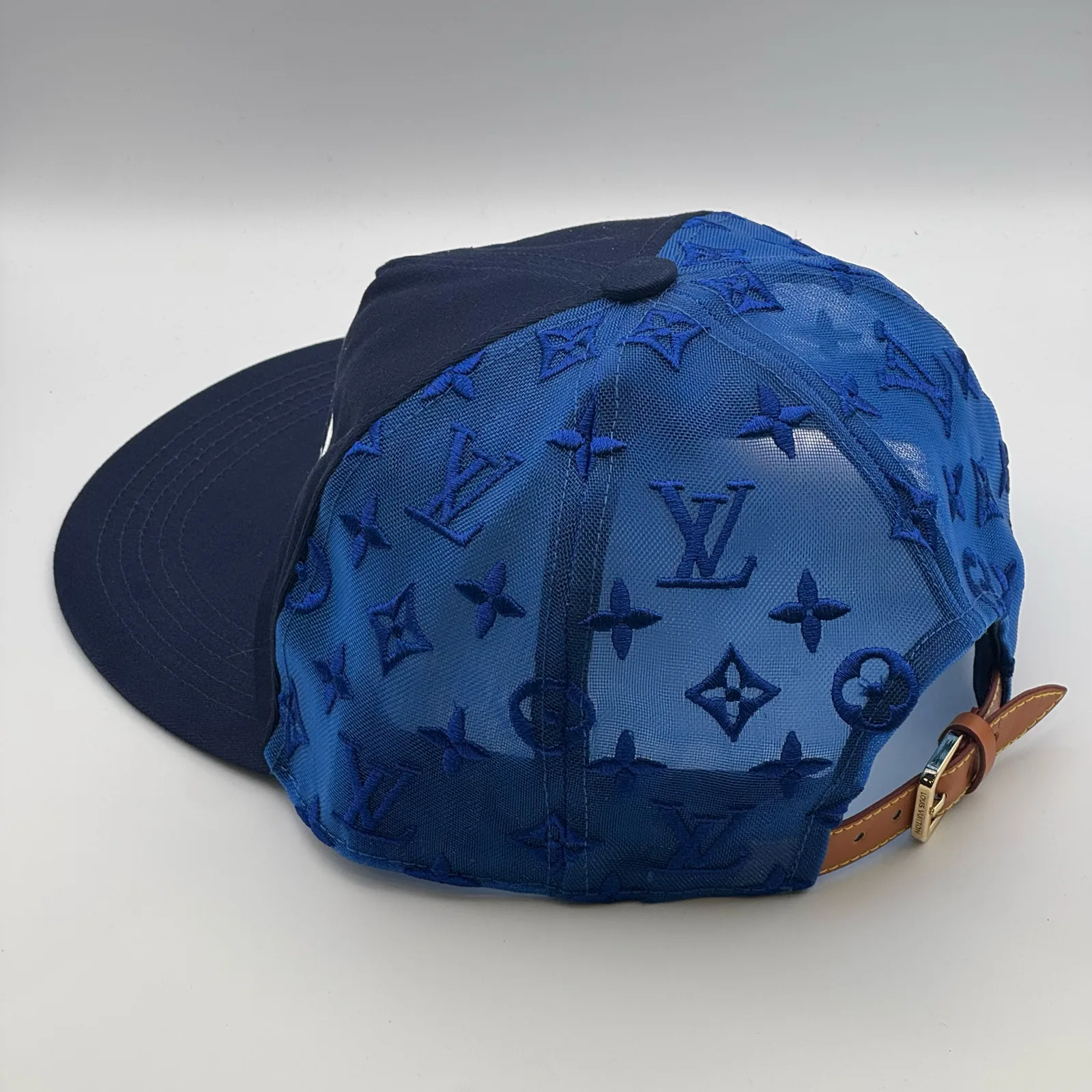 Navy logo mesh cap, three-quarter back view.