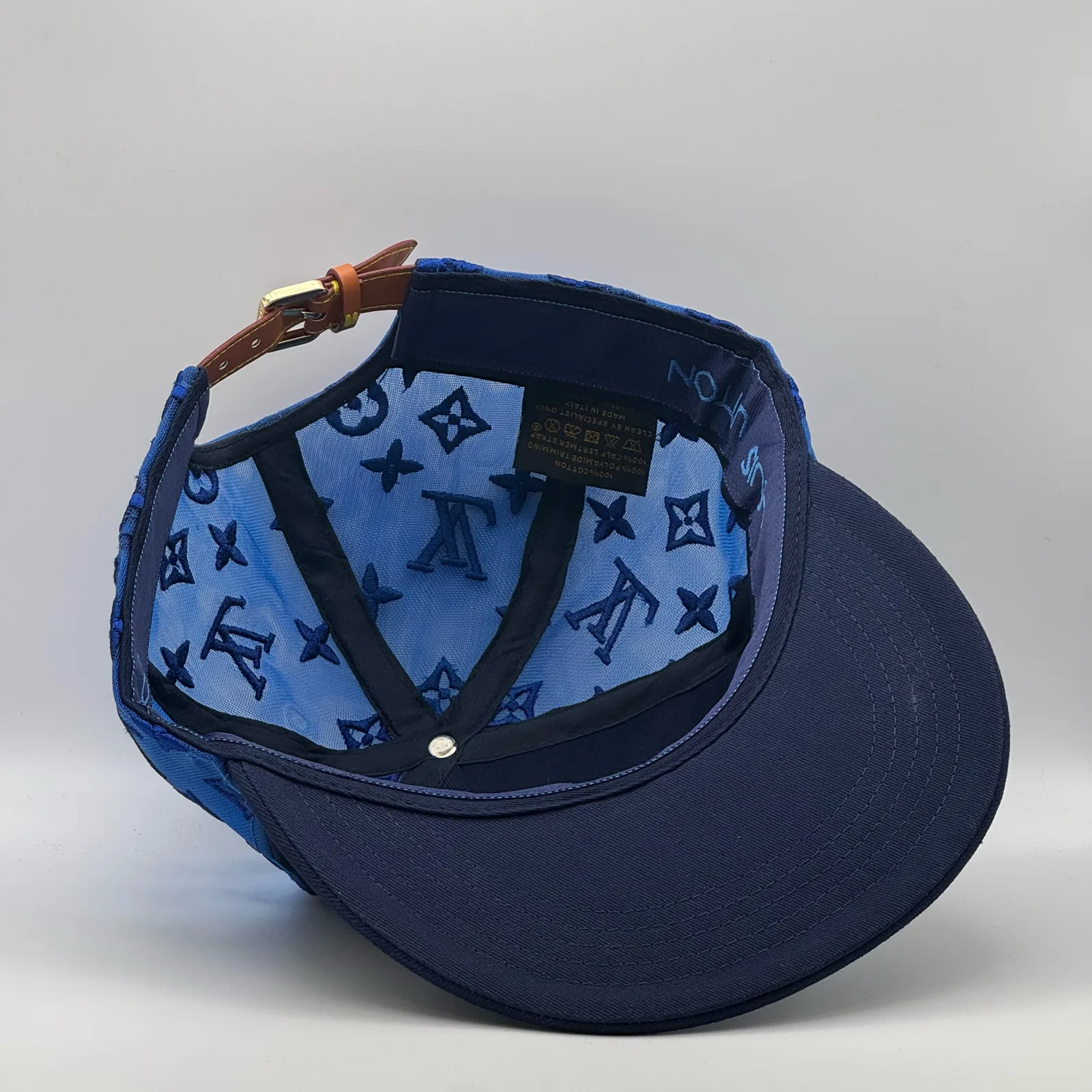 Inside view of the navy logo mesh cap showing the brand tag.