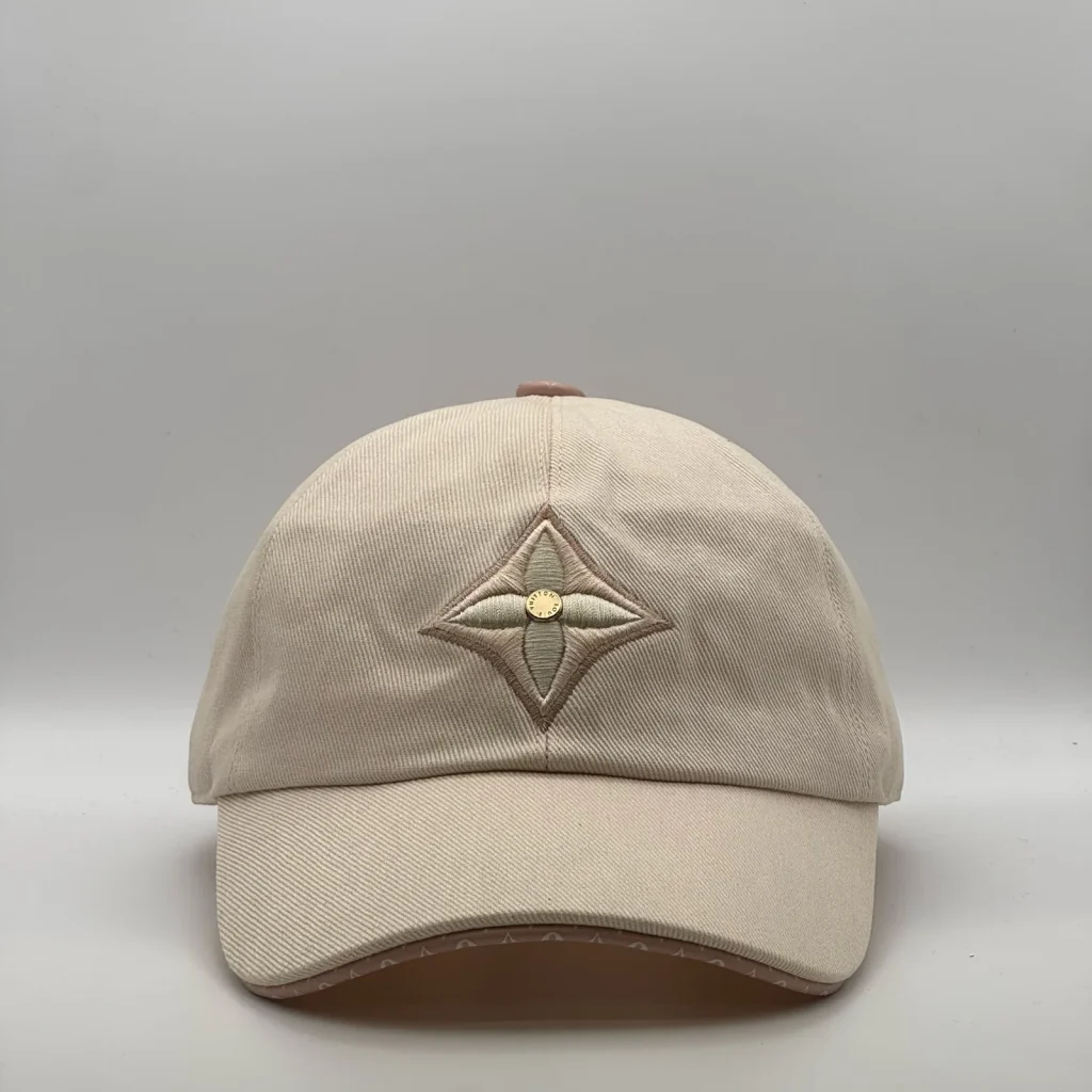 Beige Louis Vuitton Monogram Flower cap, front view showing the tonal flower emblem.